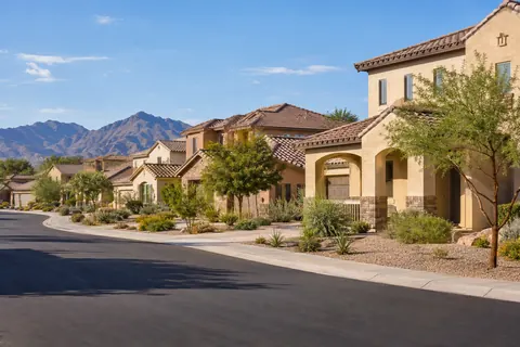 Illustrative Southwestern neighborhood street with varied homes and desert-adapted landscaping. Not a depiction of Ladera Trails Passage Collection or an available home.