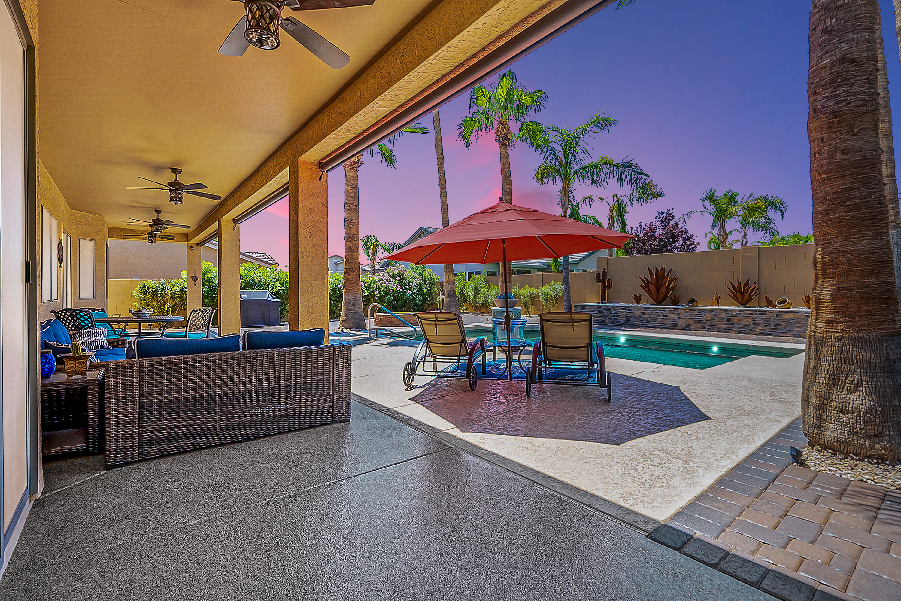 Covered Arizona backyard patio overlooking a swimming pool