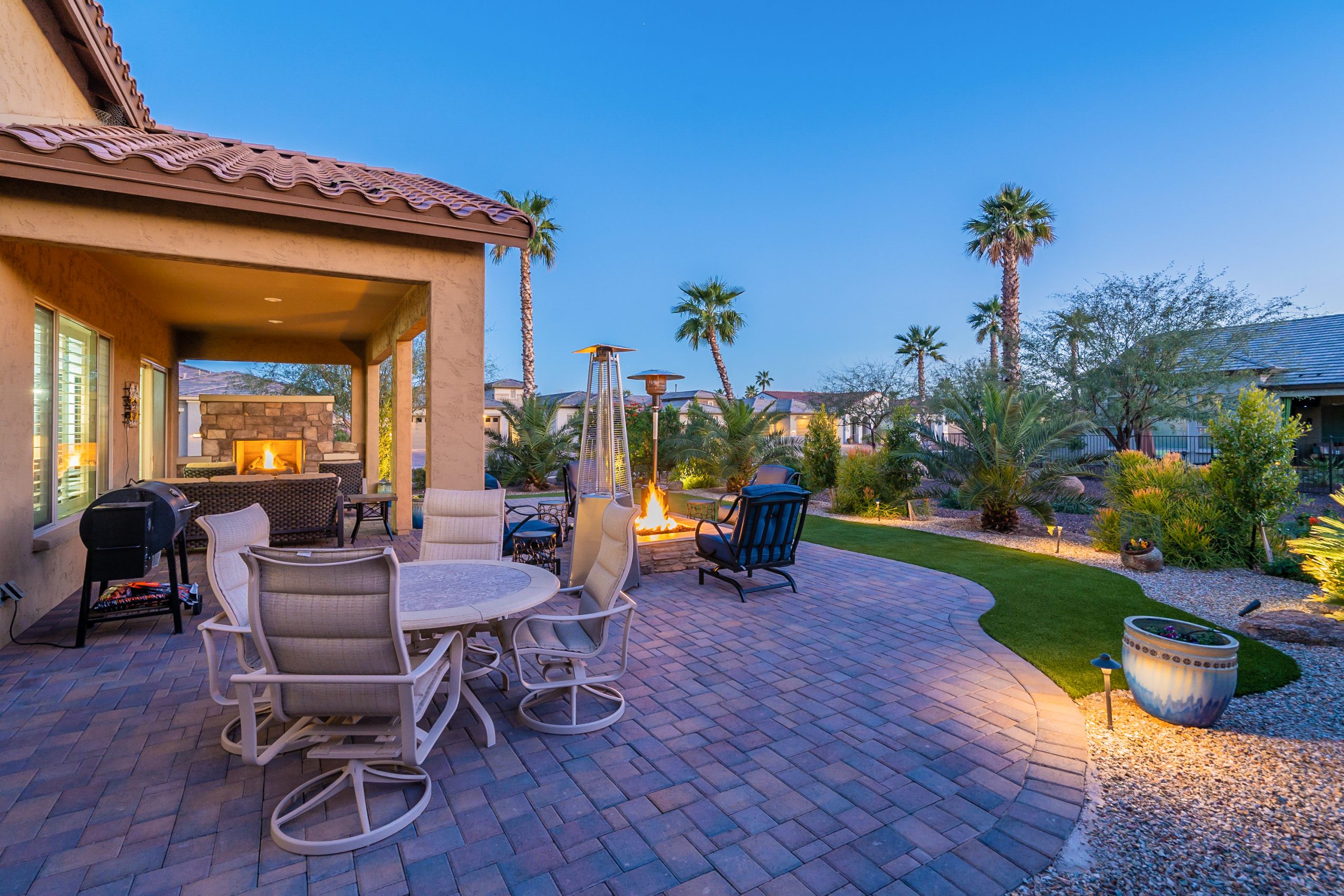 Twilight Image in Goodyear, AZ of a backyard with custom pavers and artificial grass