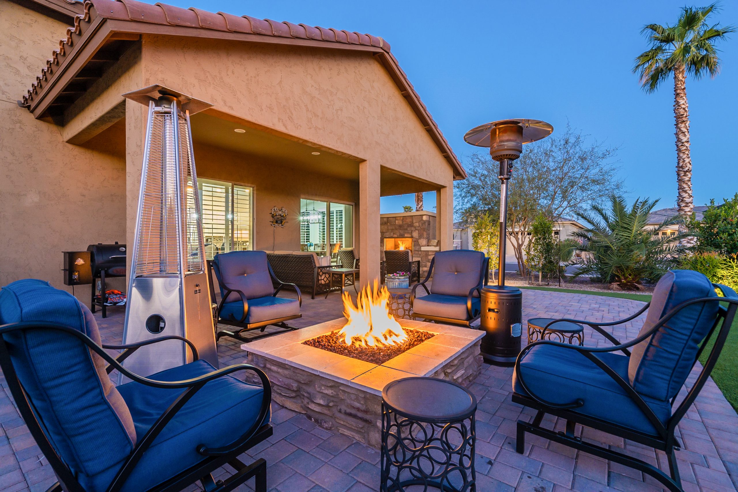 listing photo of a backyard barbecue and chairs in a listing in goodyear, az