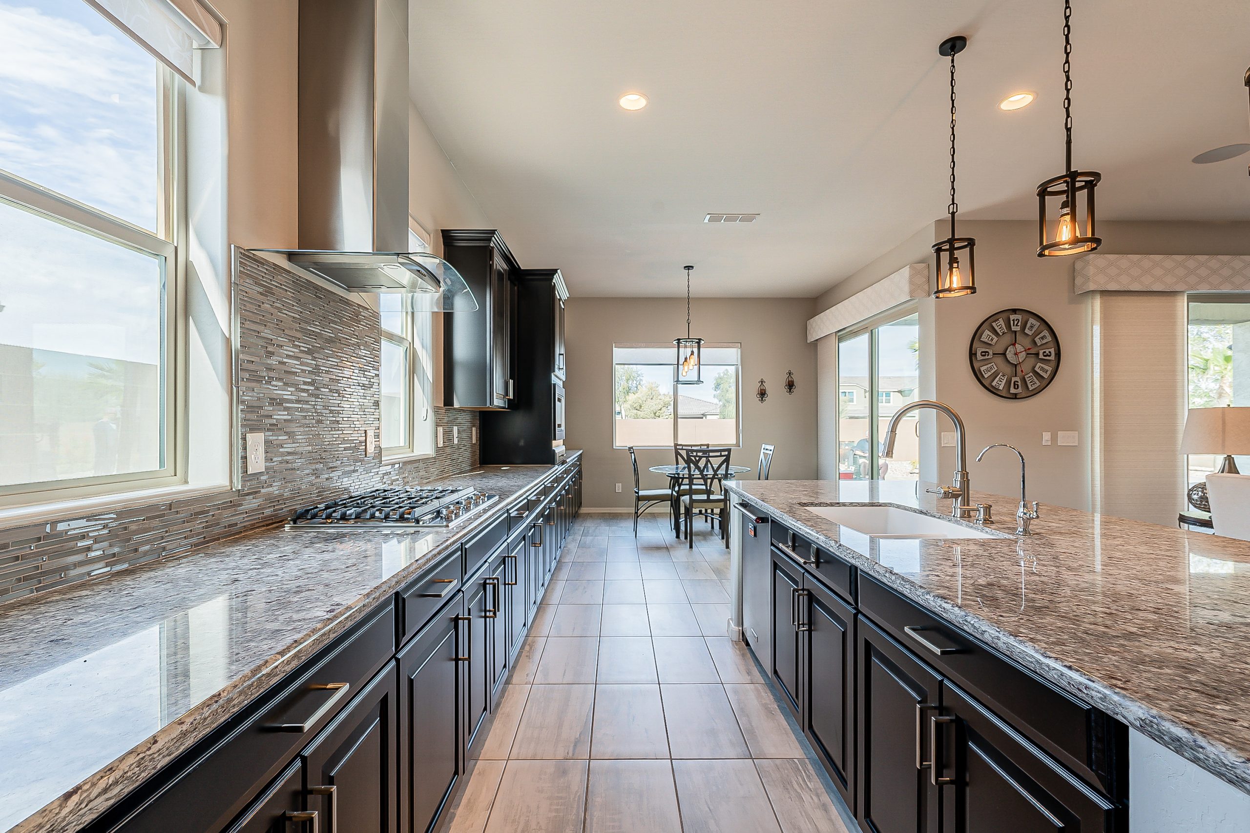 luxurious chefs kitchen inside a goodyear, az home with long extended granite countertops