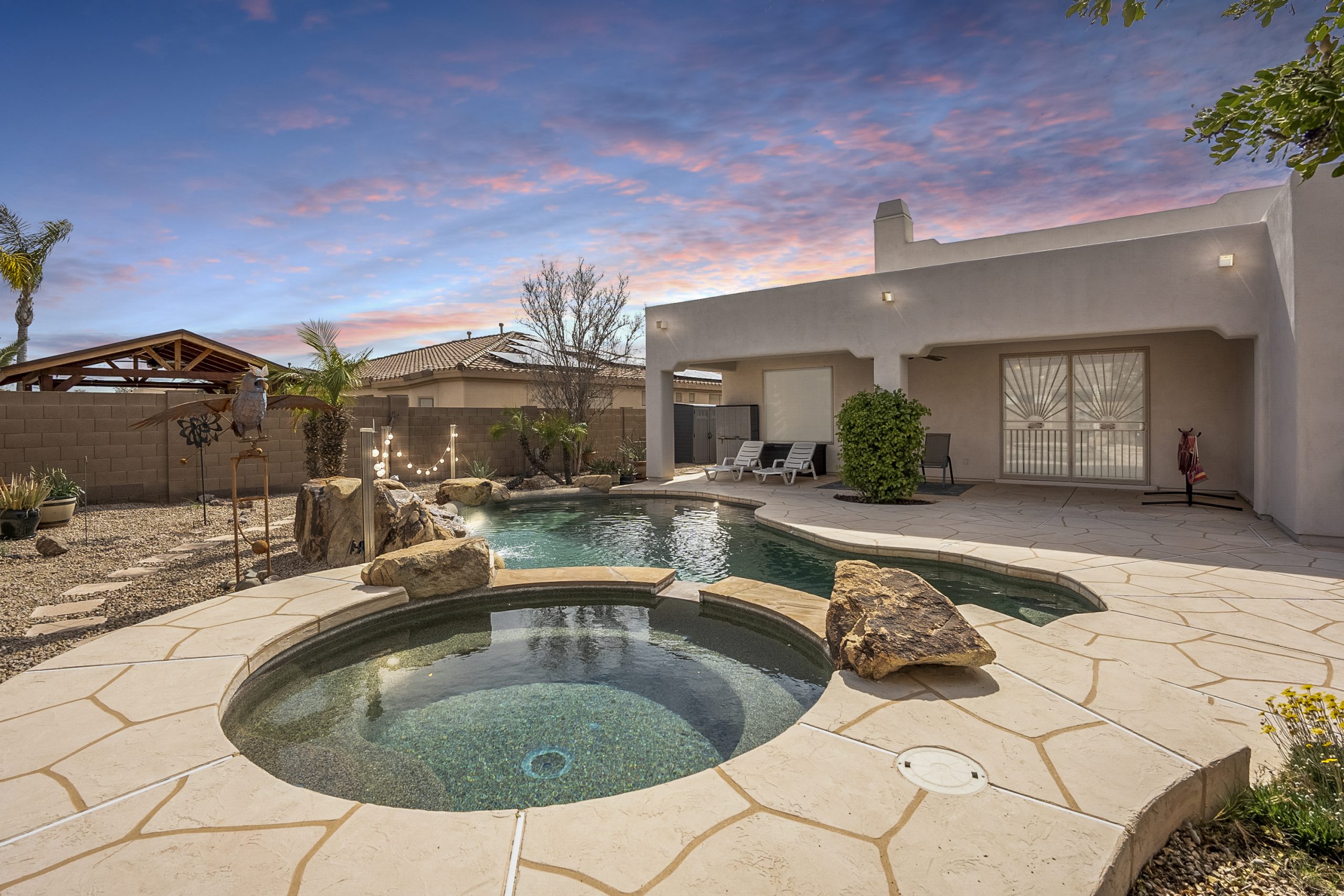 hot tub and pool in the backyard of a sold home in goodyear, az