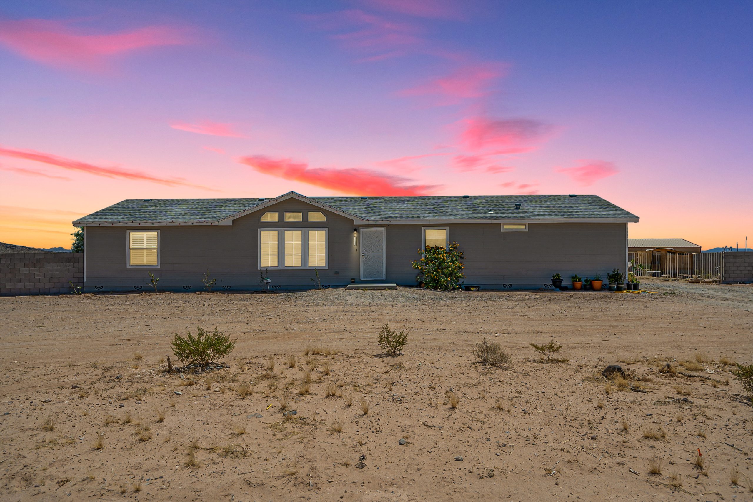 Arizona rural home on an open desert lot at sunset
