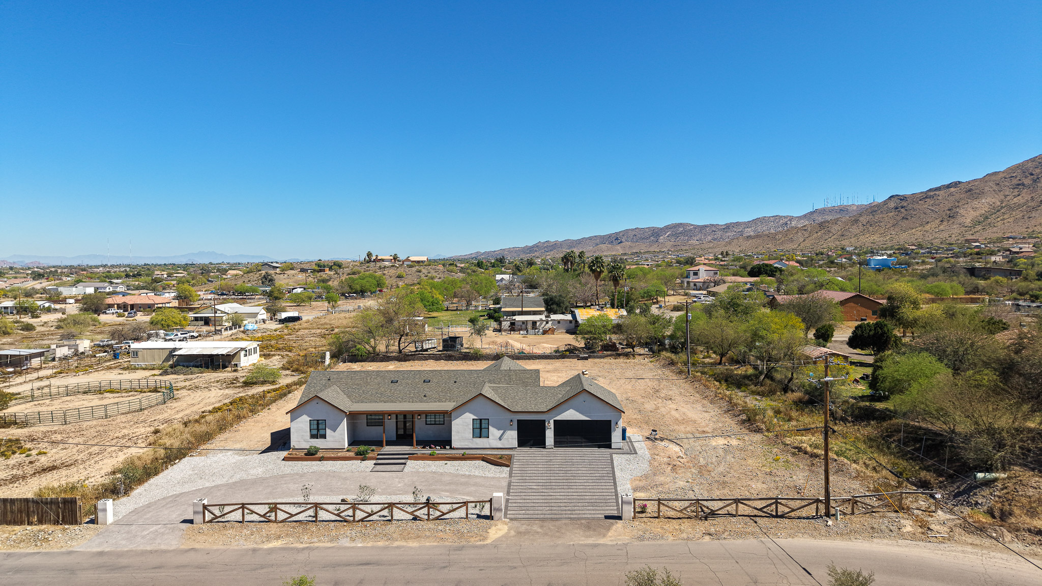 Aerial view of an Arizona home on a large desert lot near mountains