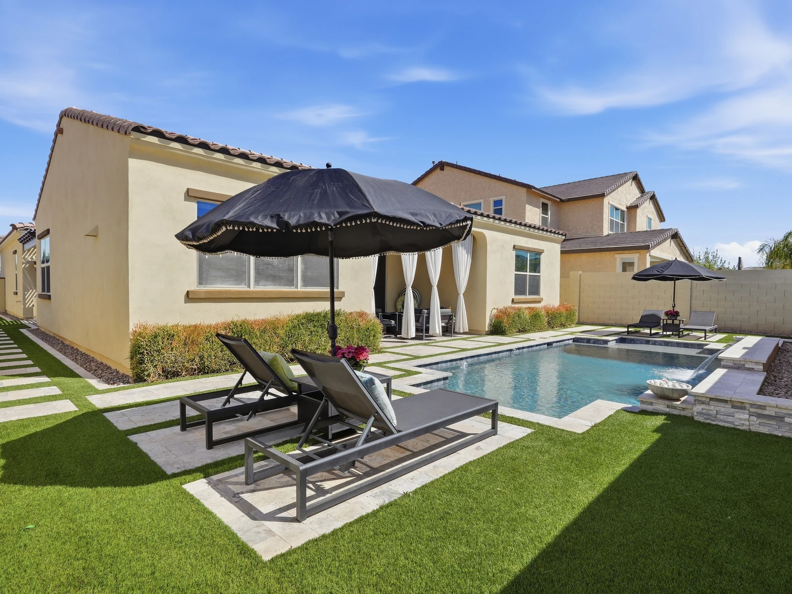 Backyard pool, lounge chairs and covered patio at a Mesa Arizona home