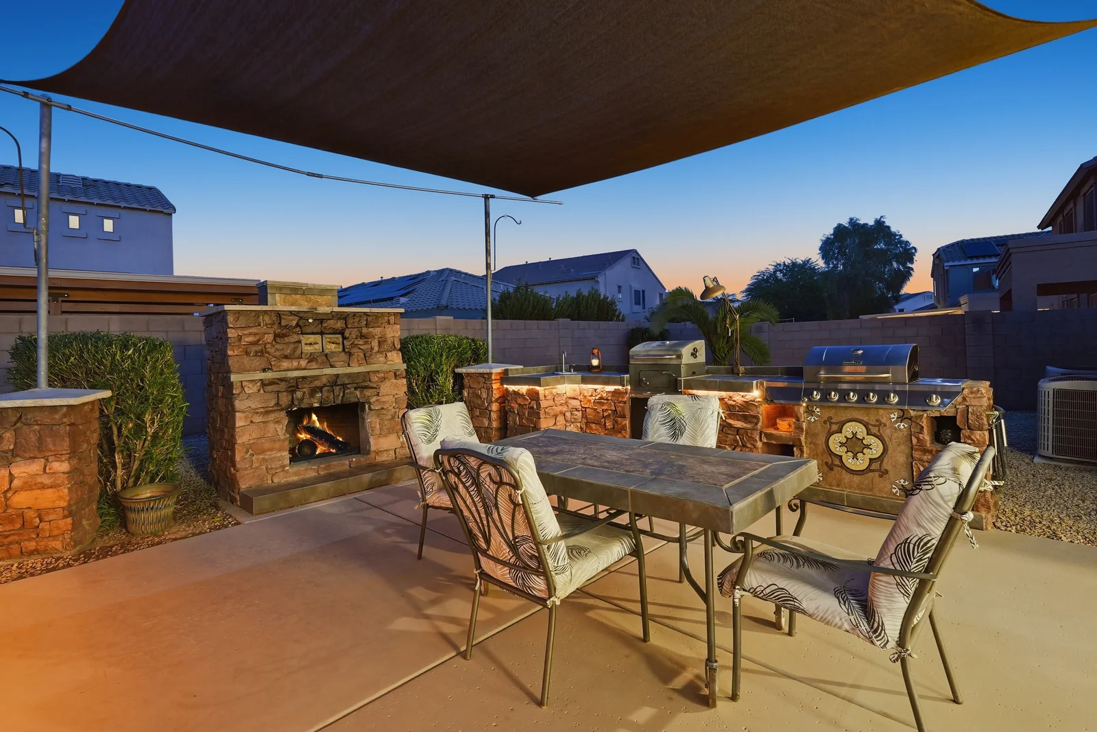 Surprise Outdoor Kitchen and Fireplace at Dusk Outdoor kitchen and fireplace photographed at dusk for a Surprise seller property
