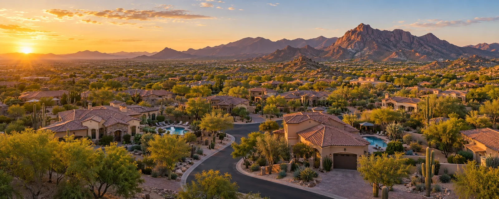 Desert homes and distant mountains in warm evening light